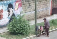 Un hombre observa conmovido un mural realizado en su honor.